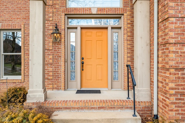 property entrance featuring brick siding