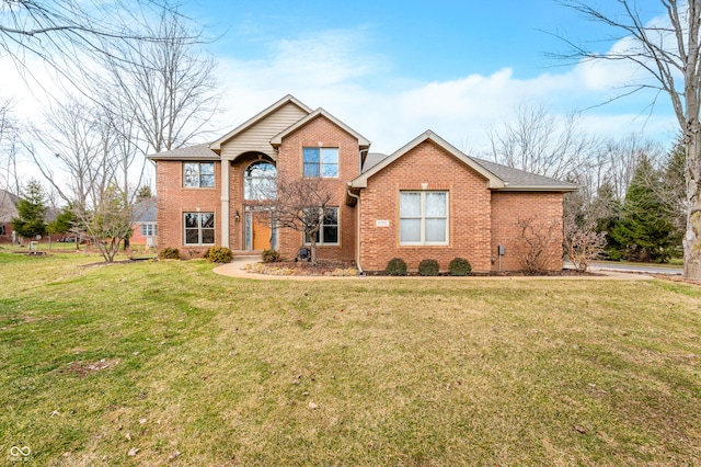 traditional home featuring a front lawn and brick siding