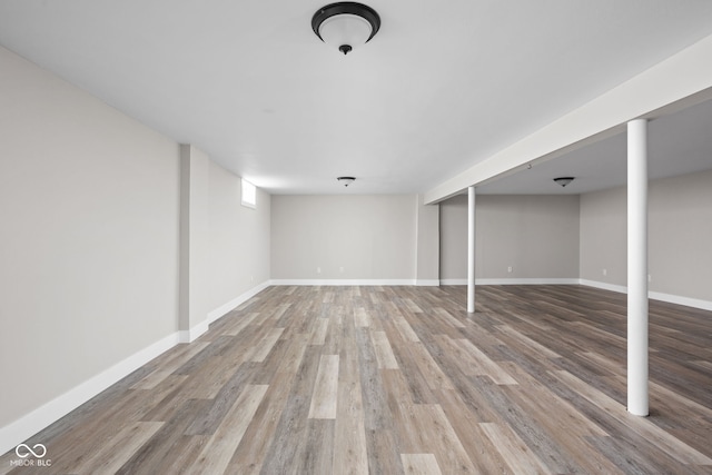 finished basement featuring wood finished floors and baseboards