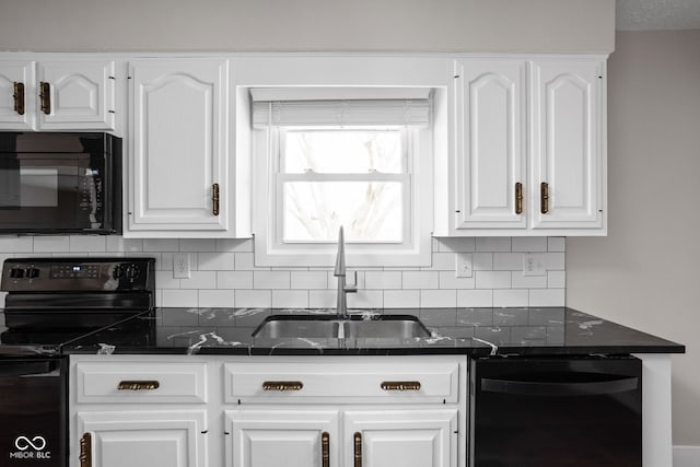 kitchen with decorative backsplash, white cabinetry, a sink, dark stone countertops, and black appliances