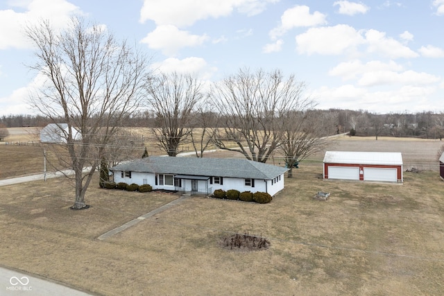 view of front facade featuring covered porch, a detached garage, and an outbuilding