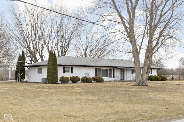 single story home with central AC, brick siding, and a front yard