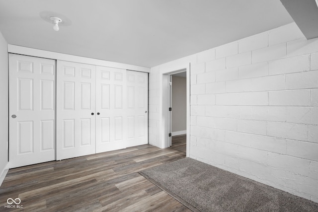 unfurnished bedroom with a closet and wood finished floors