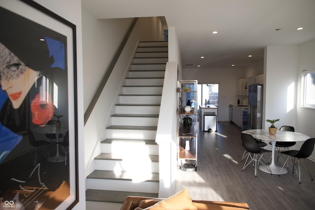 staircase featuring recessed lighting and wood finished floors