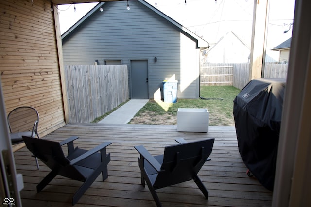 deck featuring area for grilling and fence