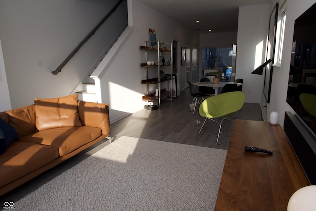 living room featuring stairs and wood finished floors