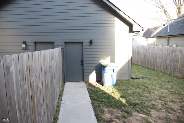 view of home's exterior featuring a yard and fence