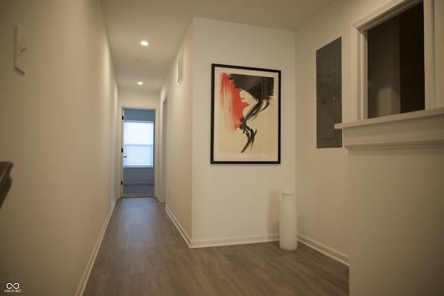 hall with wood finished floors, visible vents, baseboards, electric panel, and recessed lighting