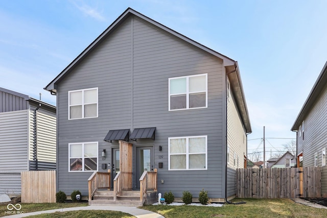 view of front of home featuring fence