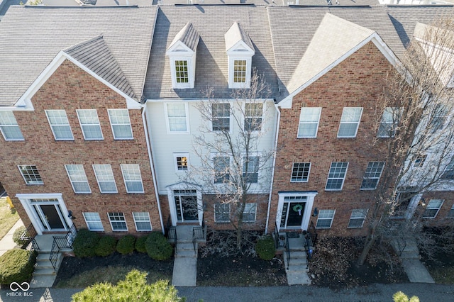 townhome / multi-family property featuring brick siding