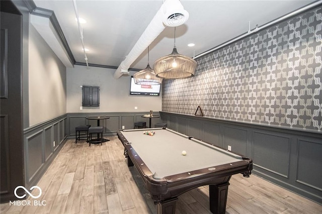 playroom featuring a decorative wall, wainscoting, and light wood-style floors