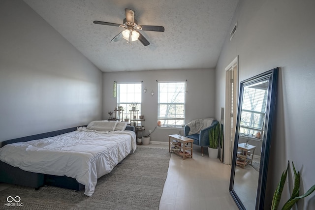 bedroom with wood finished floors, visible vents, lofted ceiling, ceiling fan, and a textured ceiling