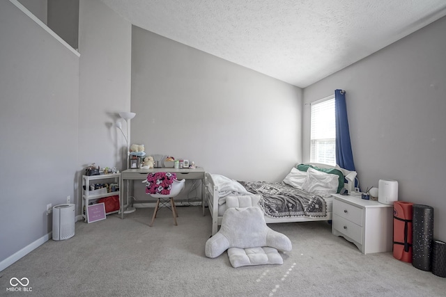 carpeted bedroom with baseboards, a textured ceiling, and lofted ceiling