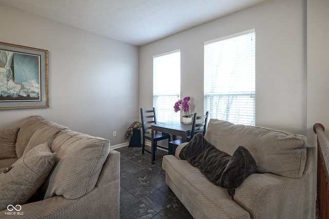 living area featuring baseboards