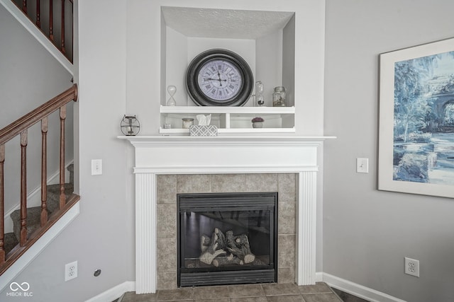 room details featuring baseboards, built in shelves, and a fireplace