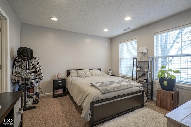 bedroom featuring multiple windows, recessed lighting, visible vents, and light carpet