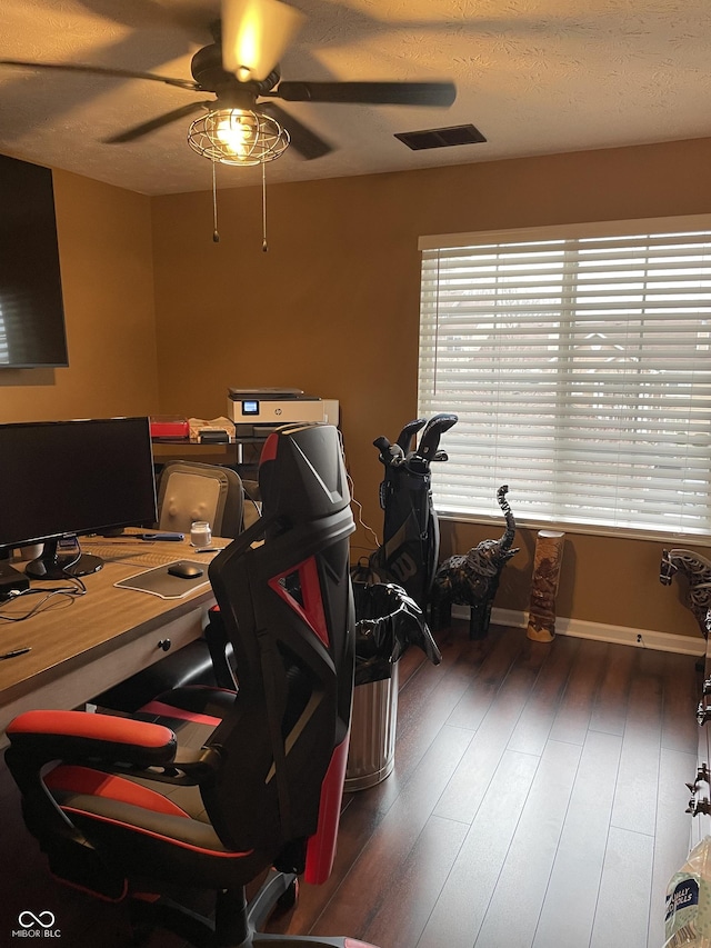 office space with visible vents, a ceiling fan, a textured ceiling, wood finished floors, and baseboards