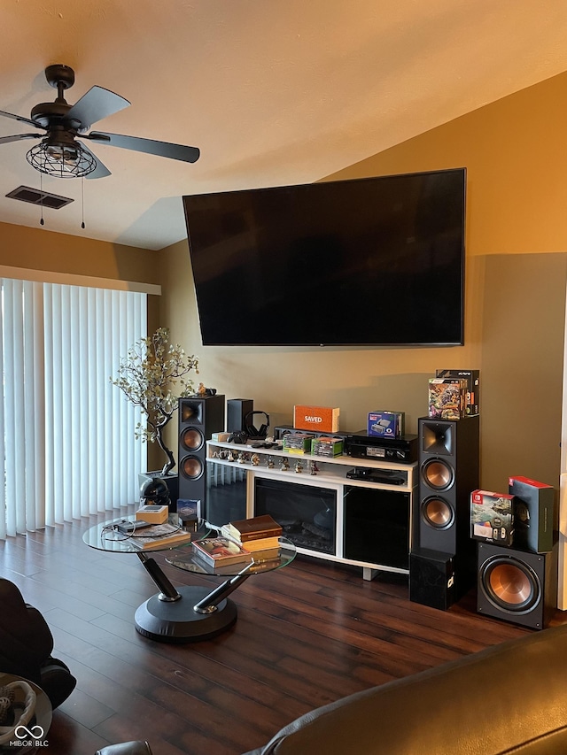 living area featuring a ceiling fan, visible vents, and wood finished floors