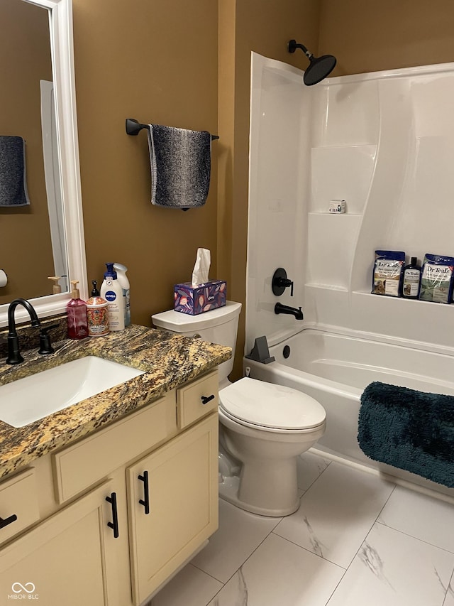 bathroom featuring toilet, marble finish floor, shower / bathing tub combination, and vanity