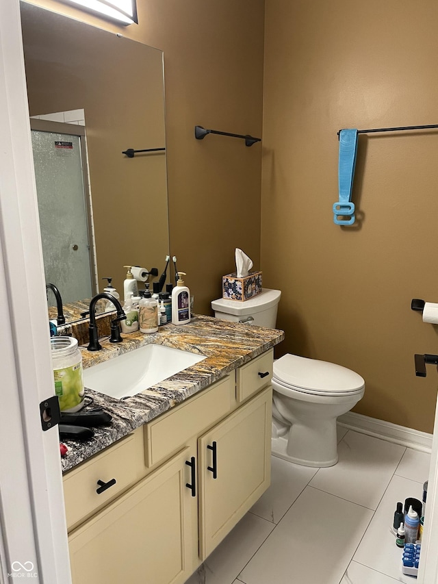 full bath with baseboards, vanity, toilet, and an enclosed shower