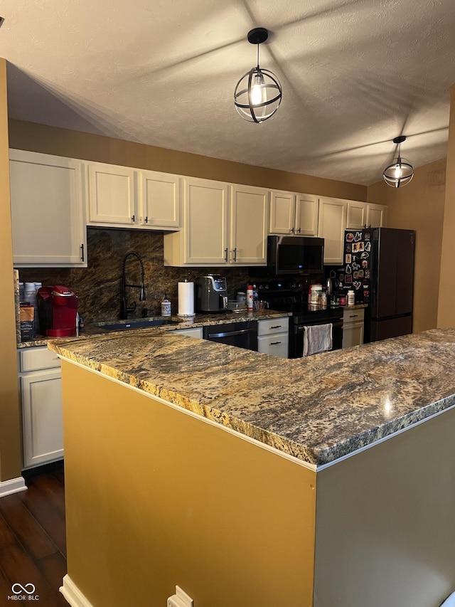 kitchen featuring dark wood-style flooring, white cabinetry, backsplash, and black appliances