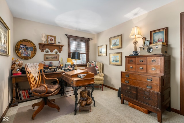 home office featuring light carpet and baseboards