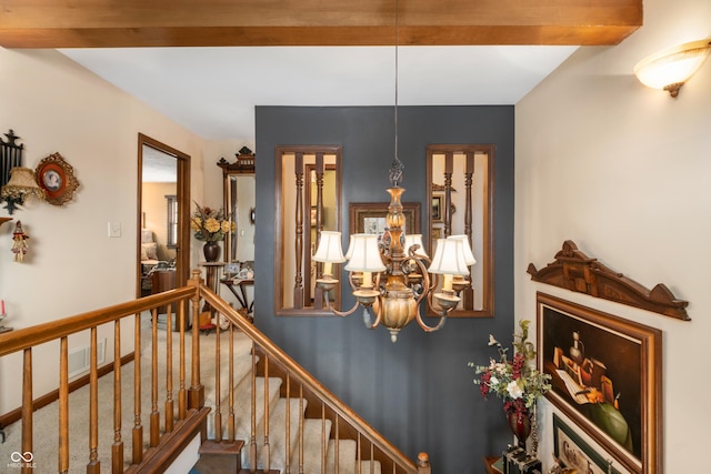 staircase with baseboards, visible vents, and an inviting chandelier