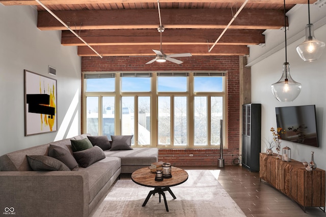 living room featuring visible vents, wood ceiling, brick wall, wood finished floors, and beam ceiling