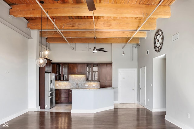 kitchen with ceiling fan, stainless steel fridge with ice dispenser, beam ceiling, decorative backsplash, and glass insert cabinets