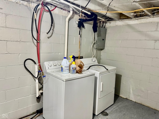 laundry area featuring laundry area, electric panel, and washing machine and clothes dryer