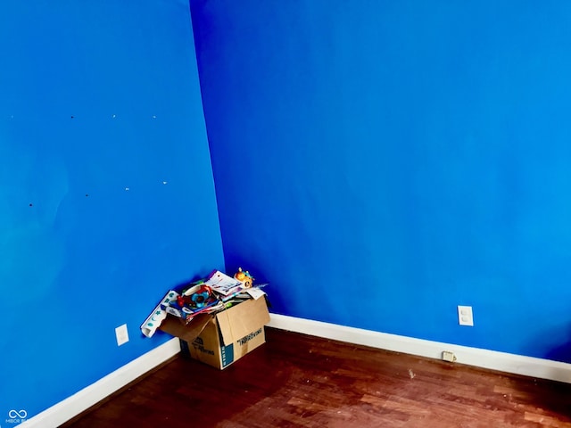 interior space with baseboards and wood finished floors