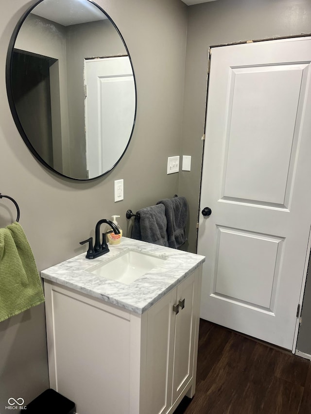 bathroom with wood finished floors and vanity