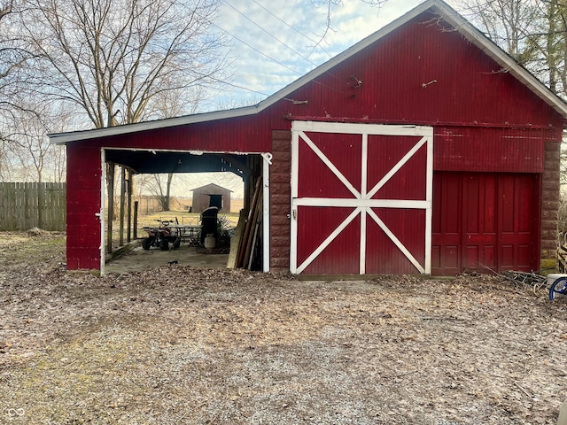 view of outbuilding with an outbuilding and fence