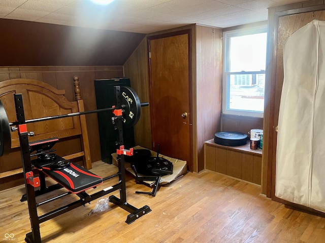 exercise room with lofted ceiling and wood finished floors