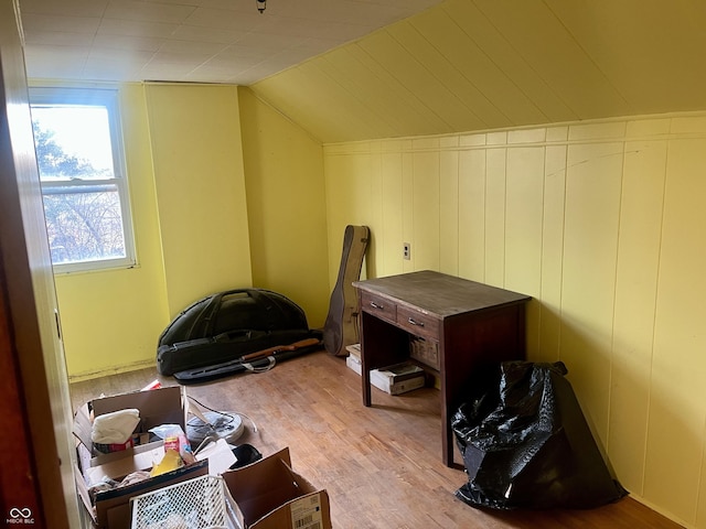 bonus room featuring light wood-style floors and vaulted ceiling