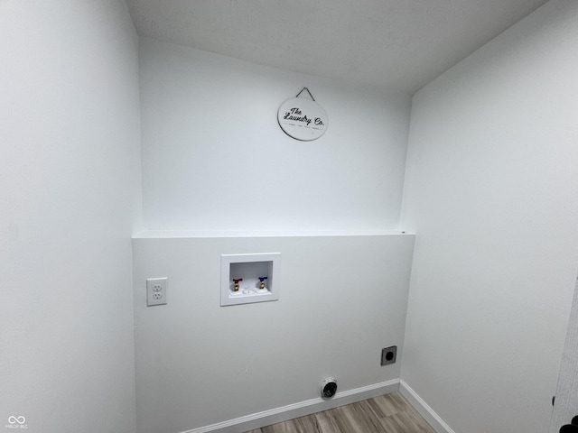 laundry area with hookup for an electric dryer, laundry area, washer hookup, baseboards, and light wood finished floors