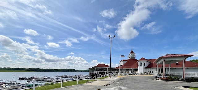 exterior space featuring a water view and street lighting