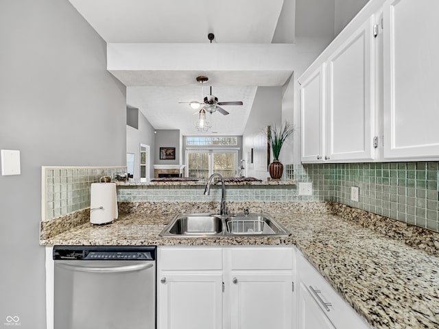 kitchen with white cabinetry, ceiling fan, a sink, stainless steel dishwasher, and tasteful backsplash