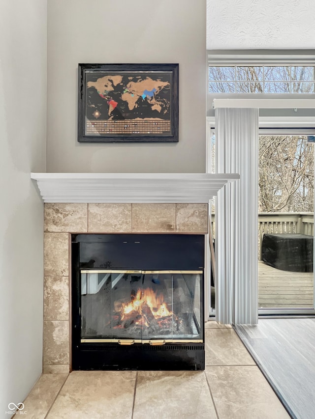 interior details featuring a tile fireplace