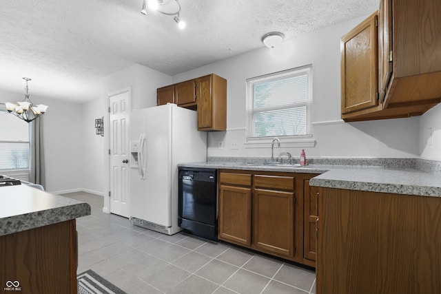 kitchen with a textured ceiling, light tile patterned flooring, a sink, brown cabinets, and dishwasher