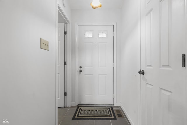 entryway featuring tile patterned flooring, visible vents, and baseboards