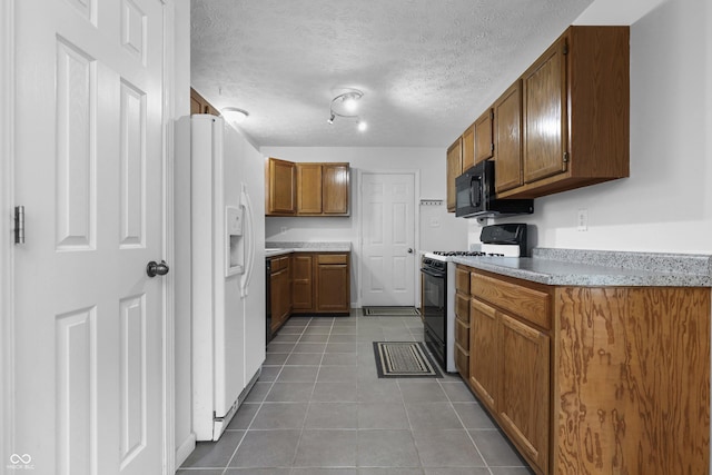 kitchen with light countertops, brown cabinetry, a textured ceiling, black appliances, and tile patterned floors