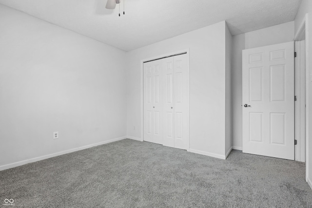 unfurnished bedroom featuring carpet floors, baseboards, and a closet