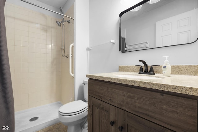 full bathroom with a shower stall, vanity, and toilet