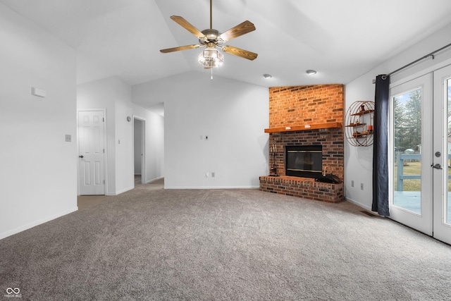 unfurnished living room with lofted ceiling, a fireplace, carpet flooring, baseboards, and french doors