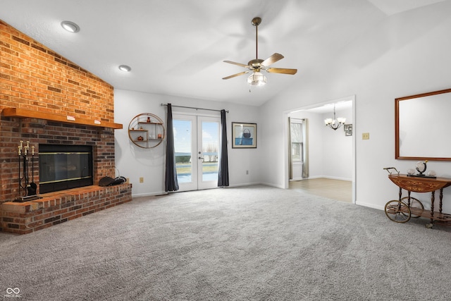 unfurnished living room with baseboards, a ceiling fan, french doors, carpet floors, and a fireplace