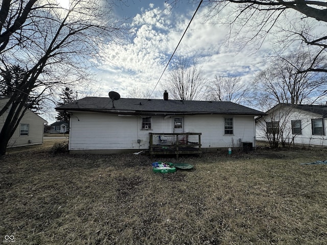 rear view of property with a deck and cooling unit