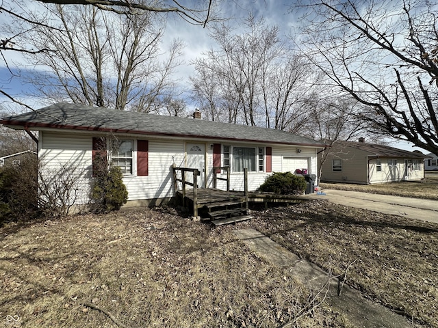 single story home with an attached garage and a chimney