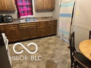 kitchen featuring light countertops and a sink