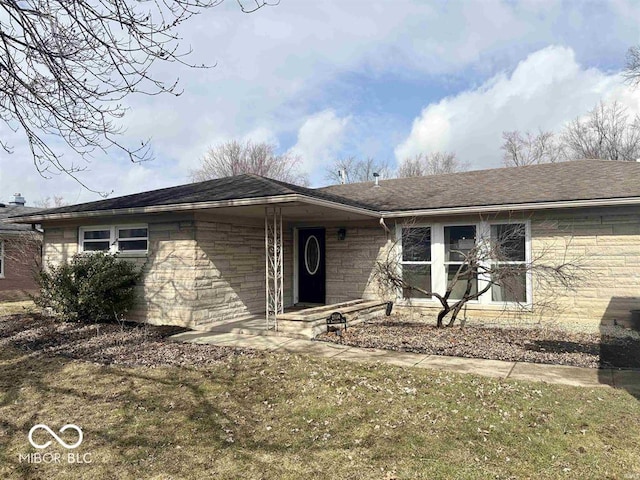 single story home featuring stone siding and roof with shingles